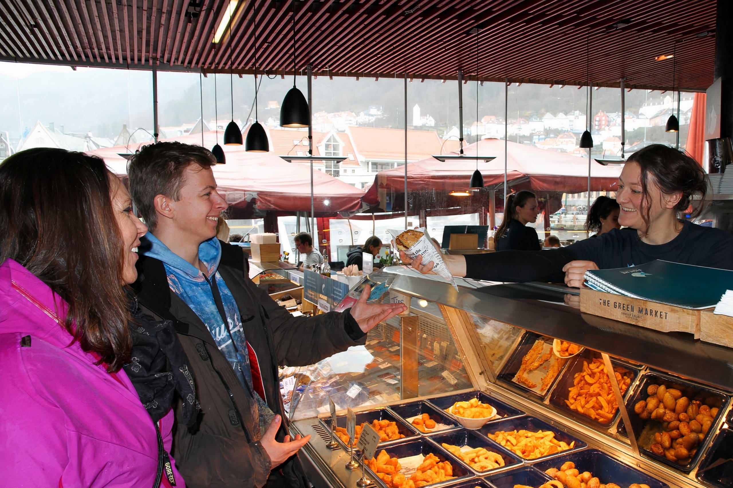 Photo of two customers receiving fishcake from a restaurant